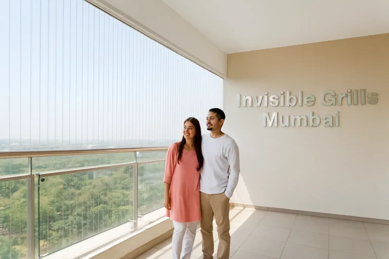 Two people smiling on a modern terrace with invisible grills and "Invisible Grills Mumbai" in the background